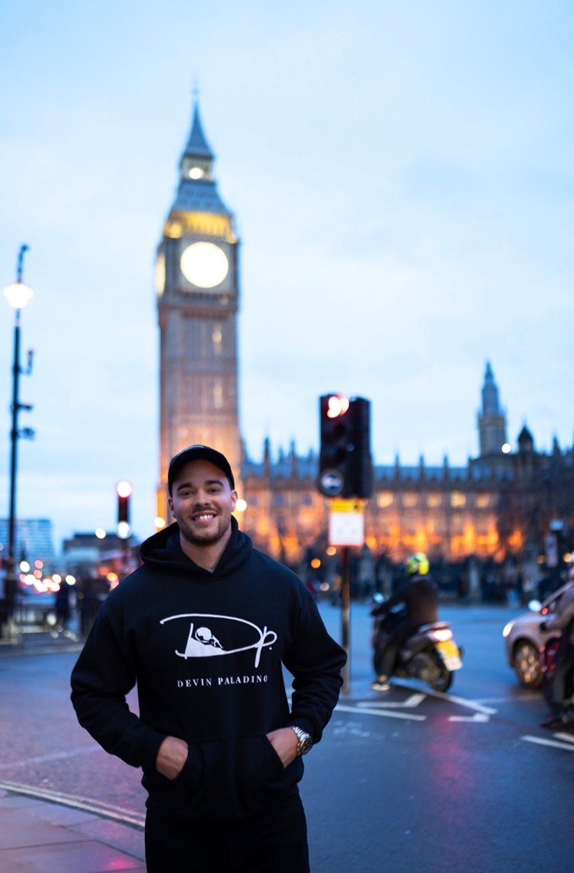 Devin Paladino in a Devin Paladino hoodie on a London street at dusk
