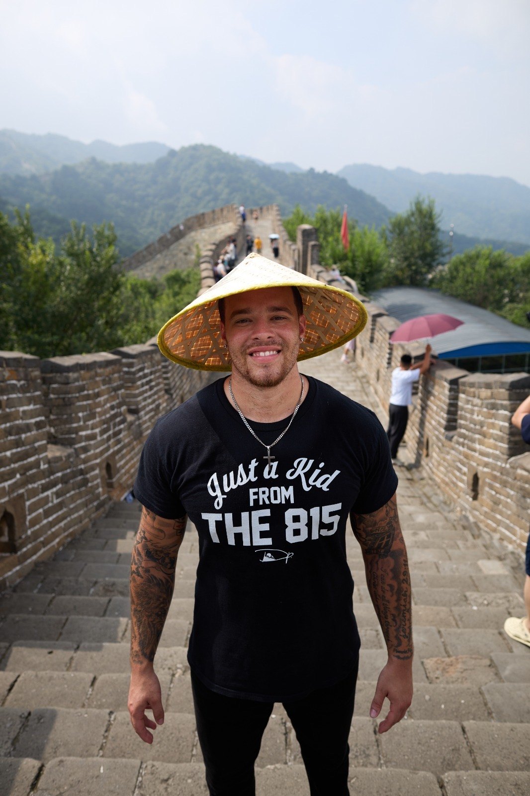 Devin Paladino on the Great Wall of China in a Just a Kid From the 815 shirt